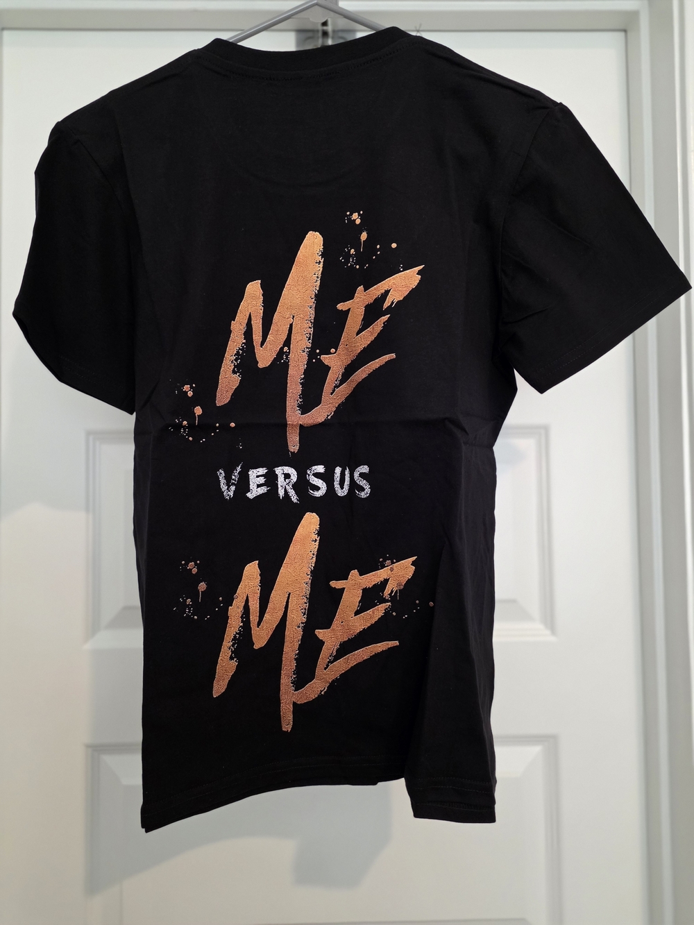 Black Short-Sleeve Graphic Tee with Orange 'Me Versus Me' Print